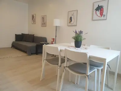 a white table and chairs in a living room at Faro Casa da Baixa in Faro