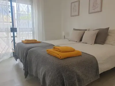 two beds sitting next to each other in a bedroom at Faro Casa da Baixa in Faro