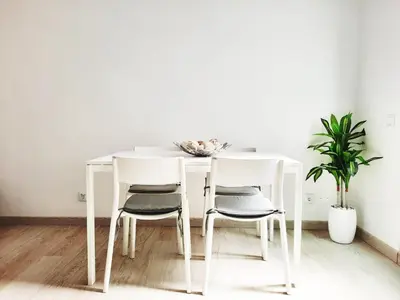 a white dining room table with four chairs at Faro Casa da Baixa in Faro