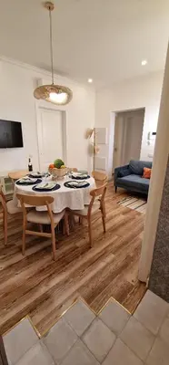 a living room with a table and a couch at Casa da Açoteia - Bright City Center Apartment with a Private Outdoor Terrace in Faro
