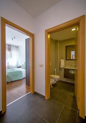 a room with a bathroom with a bed and a toilet at Blue Wave Apartment in Albufeira
