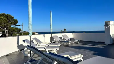 a group of lounge chairs sitting on a roof at Blue Wave Apartment in Albufeira