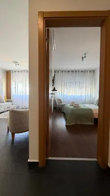 a bedroom with a bed and a living room at Blue Wave Apartment in Albufeira