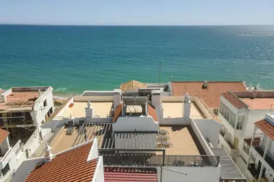 a view of the ocean from the roofs of buildings at Miral Beachside 3 - by HD Properties in Albufeira