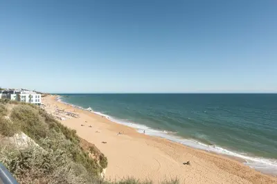 a beach with people on the sand and the ocean at Miral Beachside 3 - by HD Properties in Albufeira