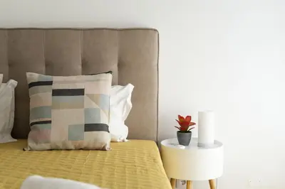 a bedroom with a bed with a pillow and a table at Miral Beachside 3 - by HD Properties in Albufeira