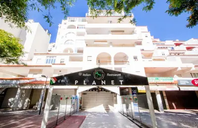 a building with a sign that reads planet at Dubai Apartment in Albufeira