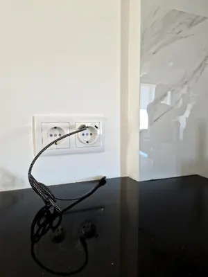 a black cord plugged into an electrical outlet in a room at MarGalé - Swimming Pool - Beach - BY BEDZY in Galé