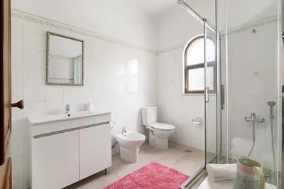a bathroom with a toilet and a sink and a shower at Casa da Oliveira in Loulé