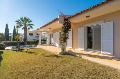 a house with a lawn in front of it at Villa Castelo Beach - Cosy modern - 500m from Castelo beach in Albufeira
