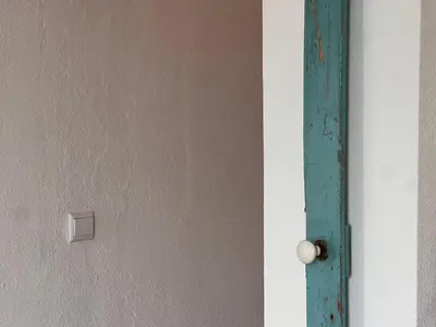 an open door with a turquoise door knob at Casa Sebastião in Faro