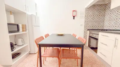 a kitchen with a table and chairs in a kitchen at Casa Sebastião in Faro