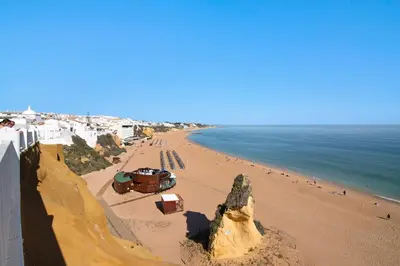 an overhead view of a beach with people and the ocean at Casa da Letinhas in Albufeira