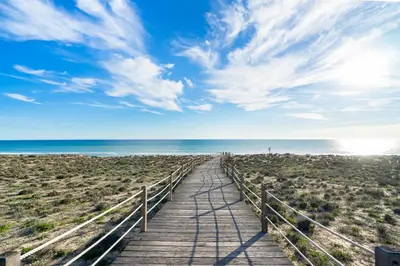 a wooden boardwalk leading to the beach at Salgados Sunny Beach Apt - 7 min walk from Beach by Lisbeyond in Guia