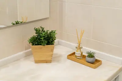 a bathroom with two potted plants on a counter at Salgados Sunny Beach Apt - 7 min walk from Beach by Lisbeyond in Guia