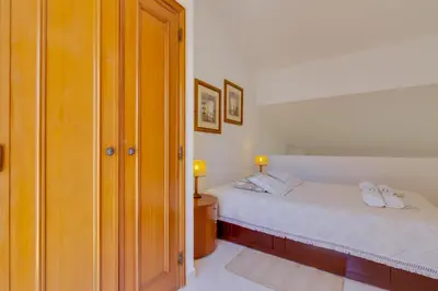 a bedroom with two beds and a closet at Small Villa 4Pax -Shared Pool @ Homesbyfc in Albufeira