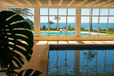 a swimming pool with a view of the ocean at BeGuest Aveiros Beach View Apartment in Albufeira