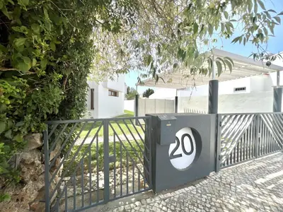 a gate with the number on it next to a house at Vila Ruby - Private Pool by HD PROPERTIES in Vilamoura