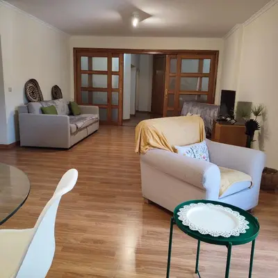 a living room with a couch and a table at Casa Alfarroba in Albufeira