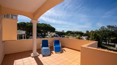 two blue chairs sitting on the balcony of a house at Amora Classic Villa in Vilamoura