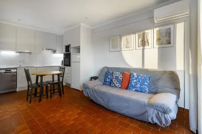 a living room with a couch and a table at Amendoeiras Family Apartment in Quarteira
