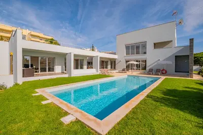 a villa with a swimming pool in front of a house at Villa L in Galé
