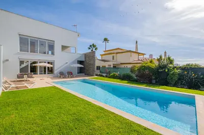 a villa with a swimming pool in front of a house at Villa L in Galé
