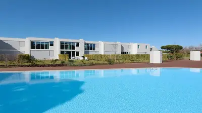 a large swimming pool in front of a building at Villa Serenity- CleverDetails, Central Vilamoura, Sleeps 4 adults and 2 children, located in the center in Vilamoura
