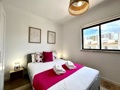 a bedroom with a bed with two towels on it at Albufeira Design by Homing in Albufeira