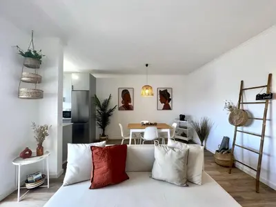 a living room with a bed and a table at Albufeira Design by Homing in Albufeira