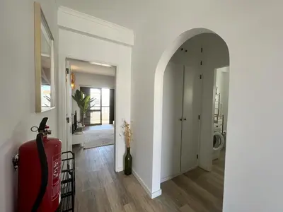 a hallway with an archway leading to a bathroom at Albufeira Design by Homing in Albufeira
