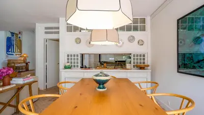 a kitchen with a wooden table with chairs and a chandelier at Quinta do Lago, Victory Village N 63 in Almancil