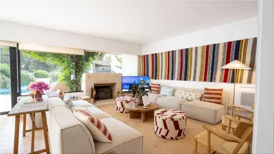 a living room with white furniture and a fireplace at Quinta do Lago, Victory Village N 63 in Almancil