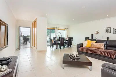 a living room with a couch and a table at Villa Seashell in Albufeira