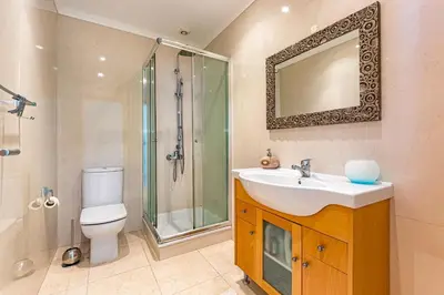 a bathroom with a sink and a shower and a toilet at Villa Seashell in Albufeira