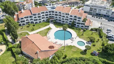a group of people on the beach with a large yellow parachute at #126 T1 Vale Mangude 213 by Home Holidays in Albufeira