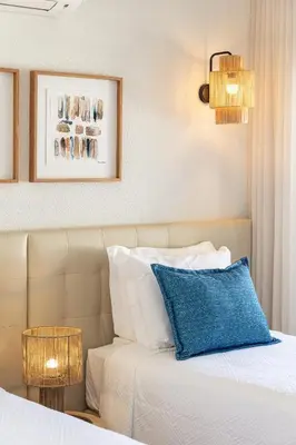 a console table with a mirror and two lamps at Apartamento do Atlantico in Albufeira