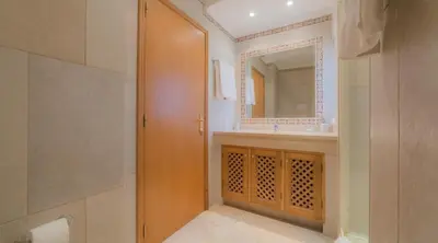 a bathroom with a sink and a mirror at Villa Tulipa - luxury golfing resorts in Almancil