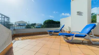 a patio with blue chairs on a balcony at Villa Tulipa - luxury golfing resorts in Almancil