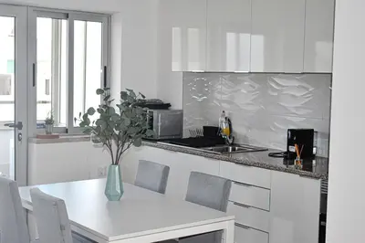 a kitchen with a table with a vase of flowers at GrowIN Stay Downtown in Faro