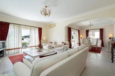 a living room with white couches and a table at Villa White Cottage by SAPvillas in Vilamoura