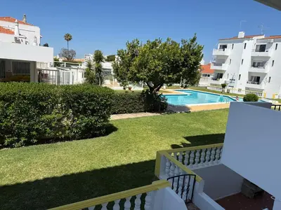 a living room with a tv and a coffee table at COZY APARTMENT OURA BEACH in Albufeira