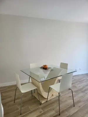 a glass table with two chairs and a bowl of fruit on it at MFA By Albufeira Rental in Albufeira