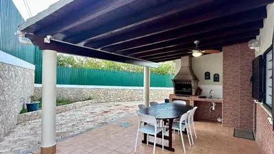 a patio with a table and chairs and a stove at Golfinho by Check-in Portugal in Albufeira