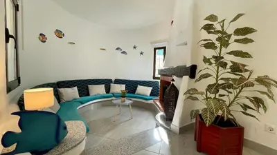 a living room with a blue couch and a plant at Golfinho by Check-in Portugal in Albufeira