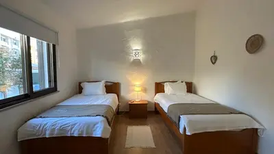 a room with two beds and a lamp in it at Golfinho by Check-in Portugal in Albufeira