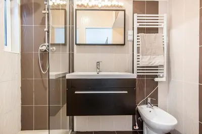 a bathroom with a sink and a toilet and a mirror at Villa Patio in Albufeira