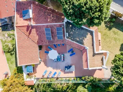 an overhead view of a large house with blue chairs at Villa Patio in Albufeira