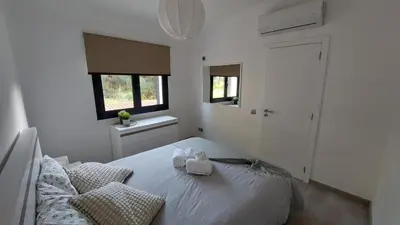 a bedroom with a bed with two towels on it at Casa Azinheira 1ºa- Albufeira in Albufeira
