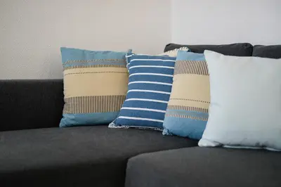 a group of pillows sitting on a couch at Sunny Albufeira - 5min to the beach by LovelyStay in Albufeira